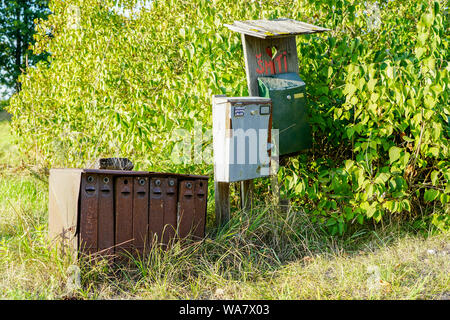 old rusty mailboxes in rural area on a green background Stock Photo