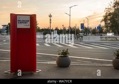 Belgrade airport Nikola Tesla sign outside of main building during sunset with golden sky Stock Photo