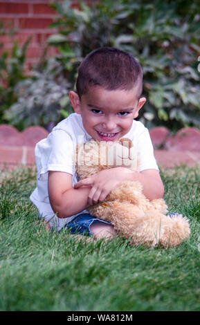 little boy hugging his favorite teddy bear Stock Photo