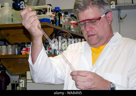 Chemist working in a lab with equipment Stock Photo