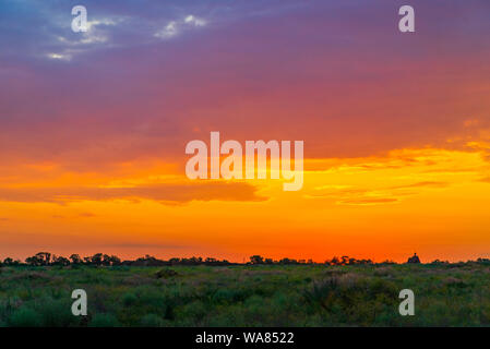 Sunset background, Panorama view with wonderful golden yellow sky, Amazing purple and orange sky in evening during the sun going down. Stock Photo