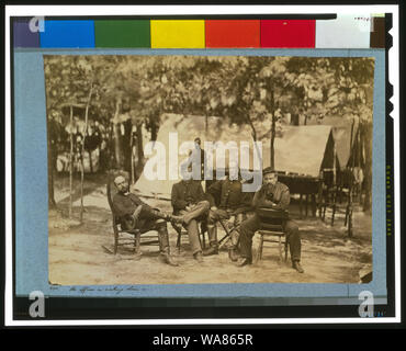 Bvt. Brig. Gen. Charles Francis Adams jr Abstract: General Charles Adams Jr., full-length portrait, seated facing front, in rocking chair next to three officers, also seated. Stock Photo