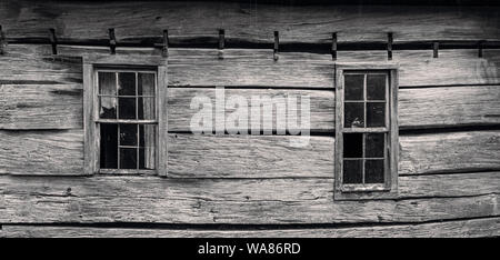 Broken windows on an old dilapidated broken down vacant home in rural Western North Carolina Stock Photo