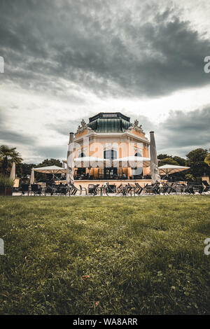 Schoenbrunn zoo imperial pavilion cafe on a sunny crowded day among green bushes in vienna austria Stock Photo