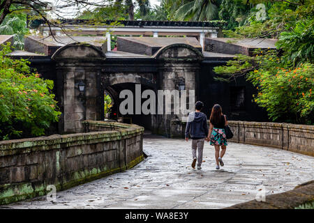 A Couple Walk Around The Old Walled City Of Intramuros, Manila, The Philippines Stock Photo