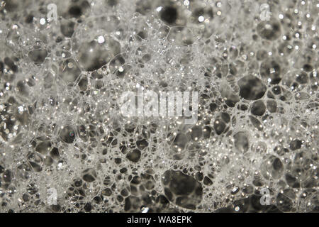 Bubbles in white foamy sea water. Stock Photo