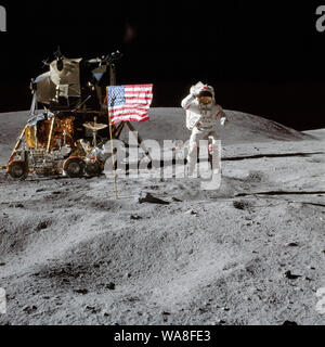 Young jumps while saluting the American flag during Apollo 16 - John W. Young on the Moon during Apollo 16 mission. Charles M. Duke Jr. took this picture. The LM Orion is on the left. April 21, 1972 Stock Photo