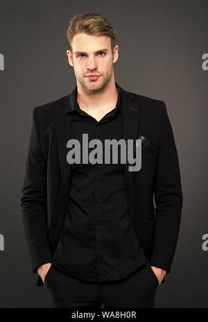 Black fashion trend. Man elegant manager wear black formal outfit on dark background. Reasons black is the only color worth wearing. Elegance in simplicity. Rules for wearing all black clothing. Stock Photo