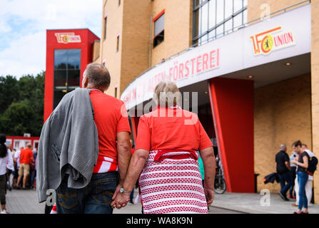 (190819) -- BERLIN, Aug. 19, 2019 (Xinhua) -- Two fans of Union Berlin prepare to enter the Stadion An der Alten Foersterei (Stadium at the old forester's house) before the first German Bundesliga match in the club's history against RB Leipzig in Berlin, capital of Germany, on Aug. 18, 2019. (Photo by Kevin Voigt/Xinhua) Stock Photo