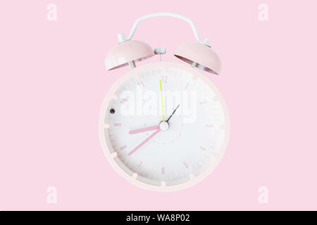 Vintage alarm clock Isolated on trendy pink background. Rest hours time of life good. Flat lay, top view, copy space, mockup Stock Photo