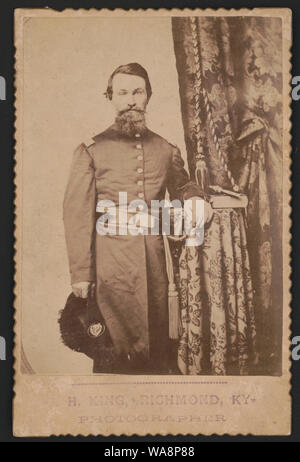 Captain John Wilson of Co. C, 8th Kentucky Infantry Regiment (Union), in uniform with sword; revolver and book rest on table] / H. King, Richmond, Ky., photographer Stock Photo