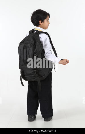 Schoolboy standing with his backpack Stock Photo