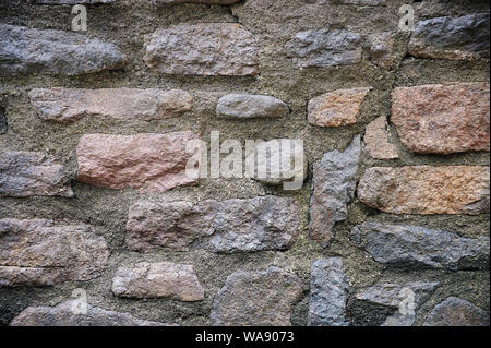 Stone bricks wall with grey cement close up view Stock Photo