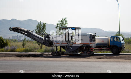 Kazakhstan, Ust-Kamenogorsk – 18 July, 2019. Cold milling machines Wirtgen. Pavement milling. Road construction on main street. Stock Photo