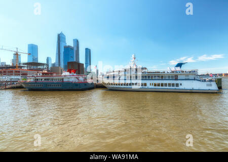 New York City/USA - May 26, 2019 New York City Harbor. Ferries and Cruise Ships. Hudson River, Manhattan Skyline, Clear Blue Sky Background. Stock Photo