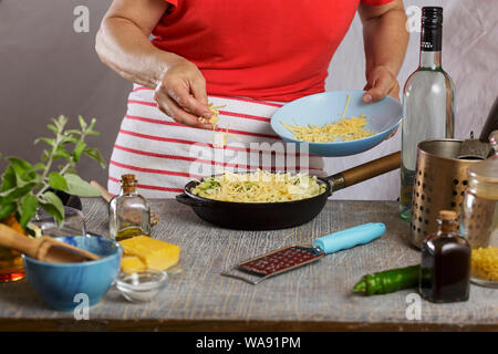 Sprinkle cheese, cheese, pasta bake, mac, hand sprinkling parmesan, parmesan cheese, shrimp, grating cheese Stock Photo