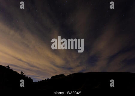 Clouds over Foel Fenlli at night in the Clwydian Range AONB Stock Photo