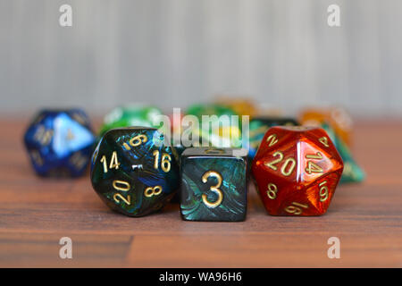Colorful red, green and blue w6 and w20 role playing dice on table with other dice in blurry background Stock Photo
