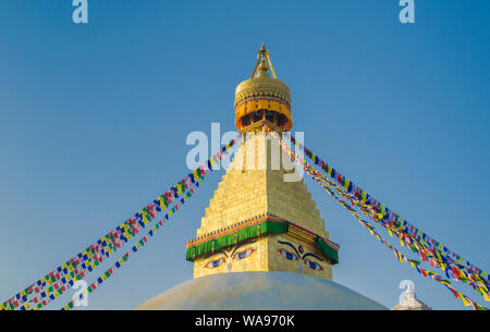 Prayer flags at the gold spire of Bodhnath Stupa, Kathmandu, Nepal Stock Photo