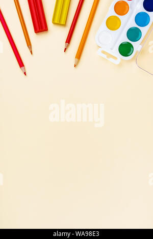 Back to school creative template with pencils, plasticine and watercolor. Composition in red and yellow tones. Stock Photo