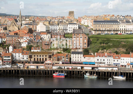 View north across the river Esk towards Whitby fish quay or Fish Market and townscape beyond, in Yorkshire, England, UK Stock Photo