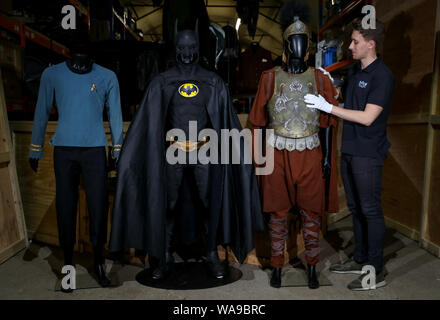 (left to right) Spock's screen matched science officer costume worn by Leonard Nimoy in Star Trek: The Ultimate Computer & The Omega Glory (TV series 1966-1969) (estimate ??50-70,000), Michael Keaton's Batsuit from the 1989 film Batman (estimate ??80-120,000) and Maximus screen matched Roman general armour worn by Russell Crowe in the 2000 film Gladiator (estimate ??30-50,000), during a preview of the forthcoming film and television memorabilia auction at the Prop Store head office near Rickmansworth. Stock Photo