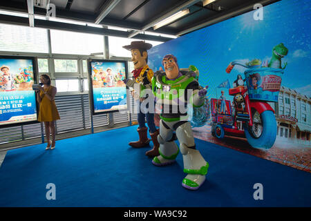 Entertainers dressed in Buzz Lightyear and Woody from Disney animated ...