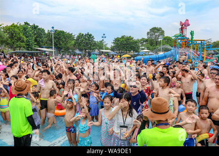 Chinese holidaymakers crowd a swimming pool at a water park on a ...