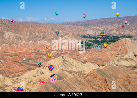 Around 100 hot air balloons fly over the Qicai Danxia scenic area of Zhangye Danxia Landform Geological Park during the first Zhangye (China) Colorful Stock Photo