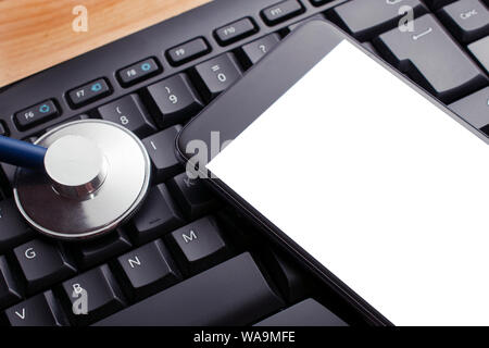 Healthcare concept: a blank screen smartphone and a stethoscope on a computer keyboard Stock Photo