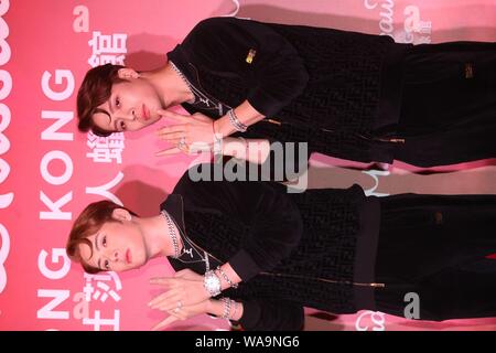 Hong Kong singer and actor Jackson Wang, right, of South Korean boy group GOT7, poses with a wax figure of him during an unveiling ceremony at Madame Stock Photo