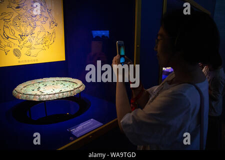 A visitor views treasures and relics from Afghan national treasures during an exhibition at a museum in Nanjing city, east China's Jiangsu province, 8