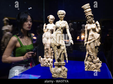 A visitor views treasures and relics from Afghan national treasures during an exhibition at a museum in Nanjing city, east China's Jiangsu province, 8