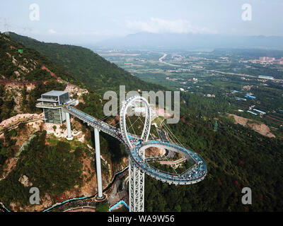 Aerial view of Guangdong's highest circular glass bridge crossing on the mountain at the Huangtengxia tourist attraction in Qingyuan city, south China Stock Photo