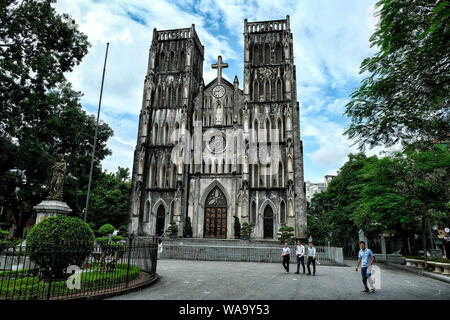 HANOI, VIETNAM - AUGUST 31: People walking near the Saint Joseph Cathedral on August 31, 2018 in Hanoi, Vietnam. Stock Photo