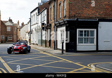 Caterham Super 7 sports car and yellow box junction in the village of Cawood, North Yorkshire, England UK Stock Photo