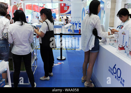 Customers visit an exhibition held to mark the 60th anniversary of iconic Chinese candy brand White Rabbit at a shopping mall in Beijing, China, 3 Jul Stock Photo