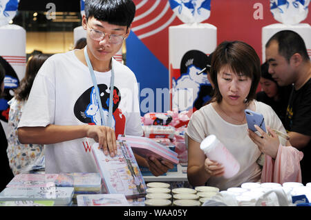 Customers visit an exhibition held to mark the 60th anniversary of iconic Chinese candy brand White Rabbit at a shopping mall in Beijing, China, 3 Jul Stock Photo