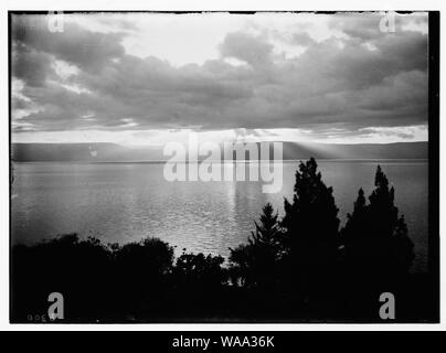 Choice set of thirteen slides, illustrating the Sea of Galilee and its fishermen still toiling with their nets. Sunrise scene at Magdala Stock Photo