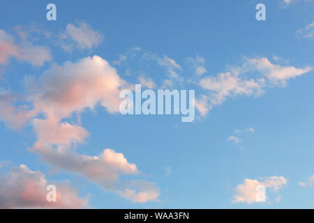 Blue sky with white, yellow and pink clouds. dawning Stock Photo