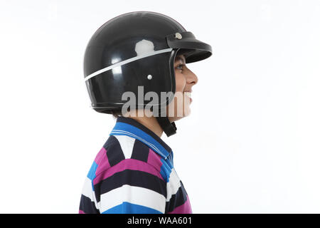 Side profile of a boy wearing helmet and smiling Stock Photo