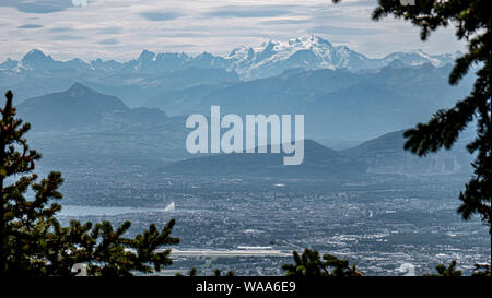 Views of alpine mountain peaks, valleys and lakes on a summer hazy day in Switzerland.