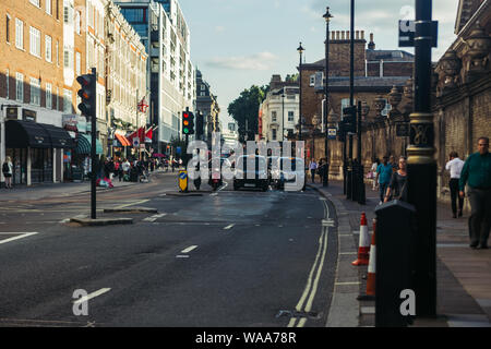 London, UK - July 15, 2019: black cabs waiting the traffiс lights on the Buckingham Palace Road towards Victoria Station.  Royal Mews on the right Stock Photo