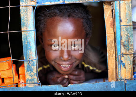 Happy girl in a small shop in a slum in Nairobi, Kenya Stock Photo