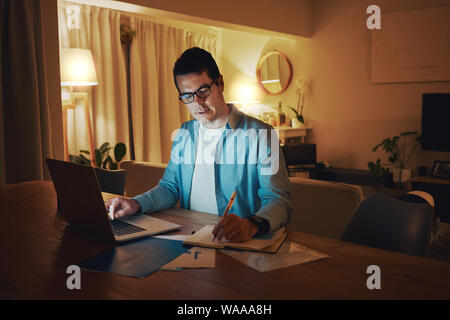 Businessman working a late night shift from home Stock Photo