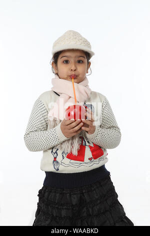 Girl drinking fruit juice with a straw Stock Photo