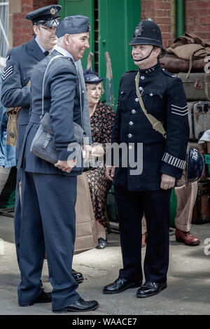 HORSTED KEYNES, SUSSEX/UK - MAY 7 :  Men in uniform at Horsted Keynes Railway Station in Horsted Keynes Sussex on May 7, 2011. Four unidentified people Stock Photo