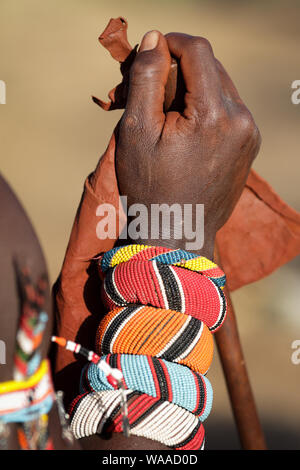 Close-up of the lower arm of a Samburu warrior in Kenya with colorful traditional bracelets and wristbands Stock Photo