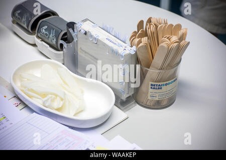 Hohen Wangelin, Germany. 25th June, 2019. Rubber gloves, mouth spatulas and arm cuffs lie on the desk of the 74-year-old country doctor Lothar Kruse in his practice. The general practitioner has been treating patients from the region in his practice in Hohen Wangelin for 40 years. At the end of 2019, Kruse wants to give up his practice, but has so far unsuccessfully sought a successor. Credit: Jens Büttner/dpa-Zentralbild/ZB/dpa/Alamy Live News Stock Photo