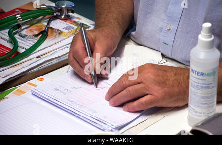 Hohen Wangelin, Germany. 25th June, 2019. 74-year-old country doctor Lothar Kruse issues a prescription. The general practitioner has been treating patients from the region in his practice in Hohen Wangelin for 40 years. At the end of 2019, Kruse wants to give up his practice, but has so far unsuccessfully sought a successor. Credit: Jens Büttner/dpa-Zentralbild/ZB/dpa/Alamy Live News Stock Photo